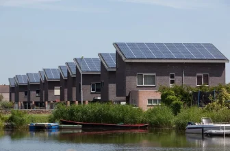 A row of houses with solar panels in rural landscape