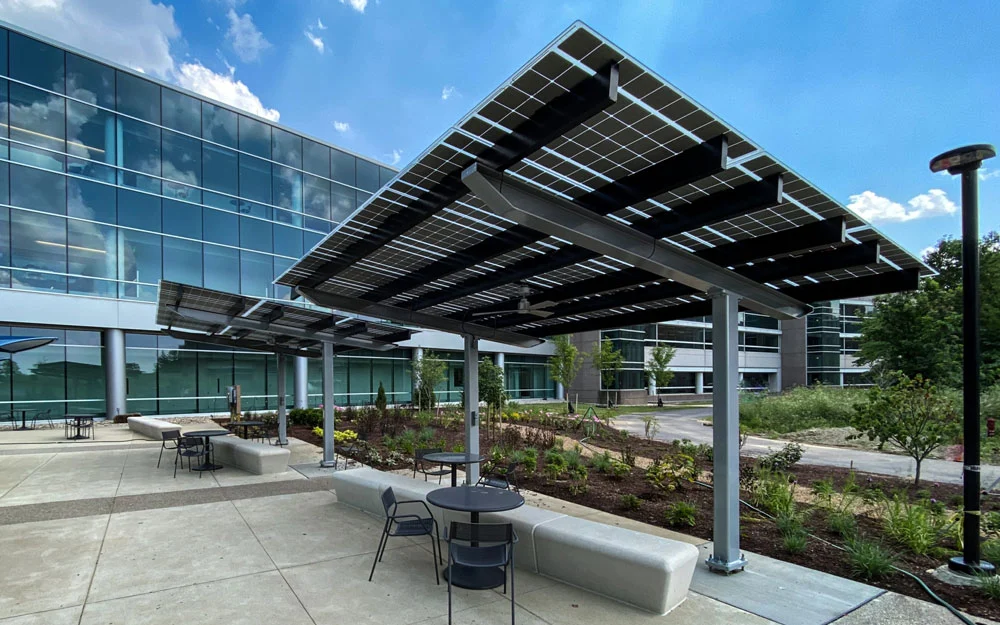  Residential metal shade with integrated solar cells near glass buildings.